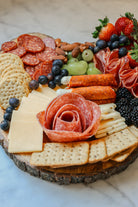 Charcuterie board with crackers, cheese, meats and fruits