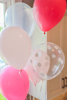 Various shades of pink and white balloons