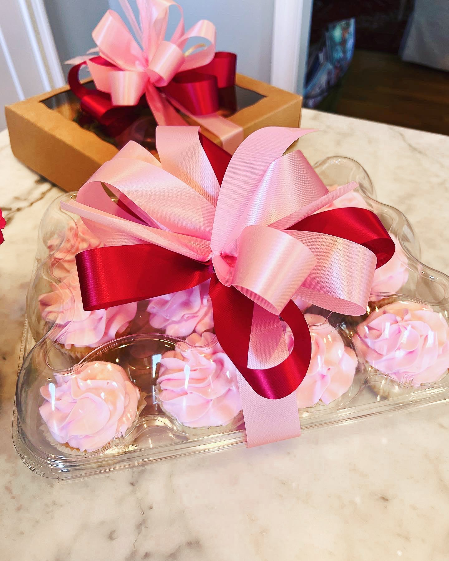 Pink cupcakes packaged with a bow for delivery in Tuscaloosa Alabama