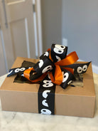 Packaged with a black and orange bow for halloween delivery.