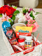 Basket of get well soon goodies, including gatorade, medicine, soup, and flowers