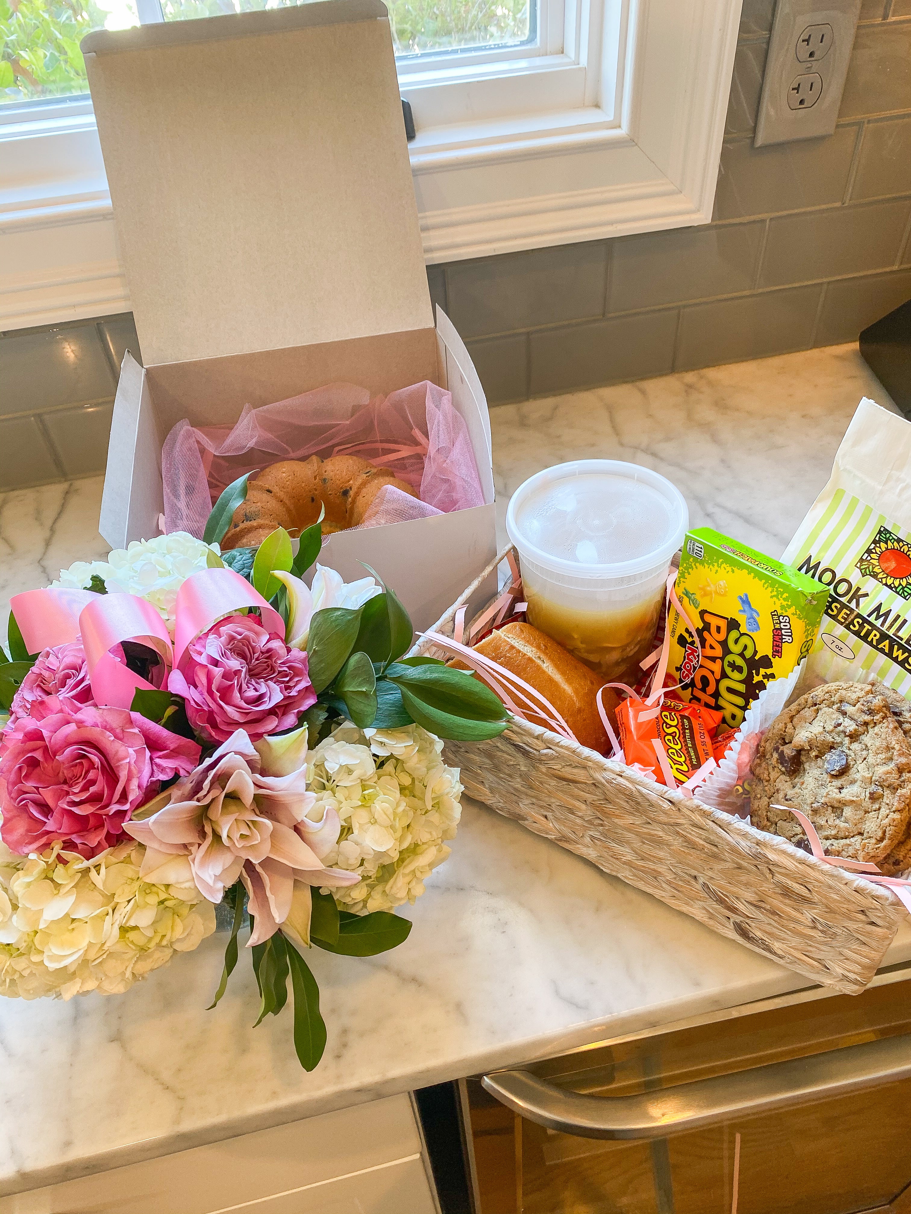 Get well soon basket with flowers, cake, soup and treats