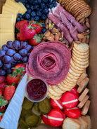 Charcuterie board with crackers, cheese, meats, nuts and fruits